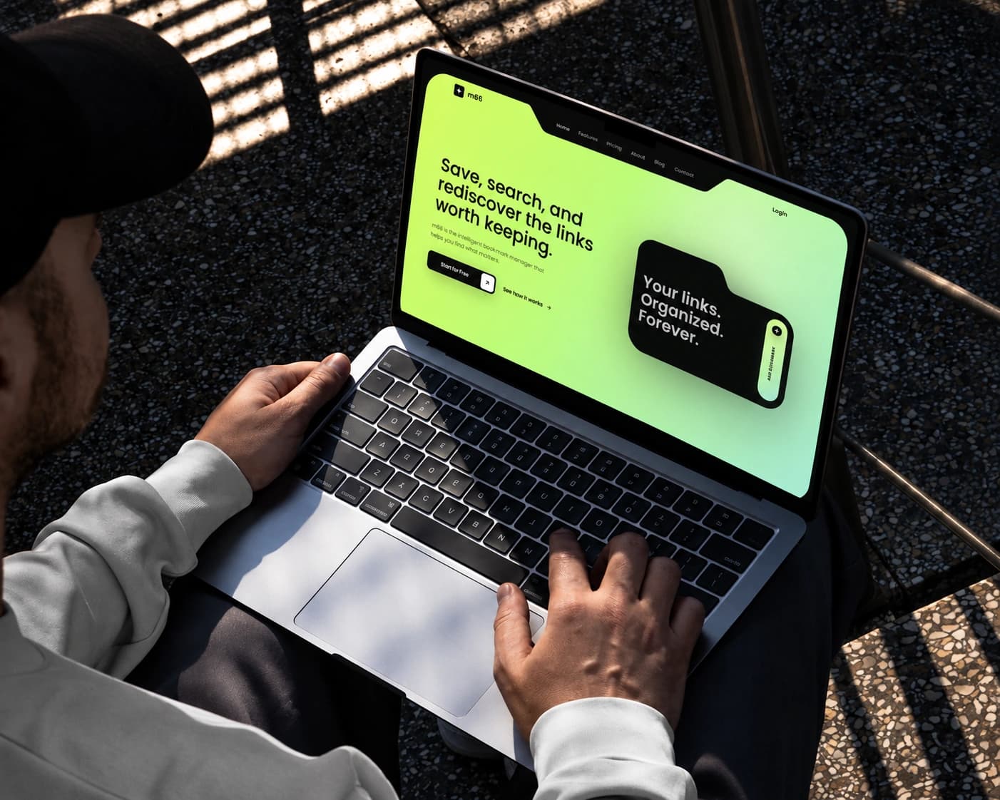 m66 homepage displayed on a laptop in a sunlit setting